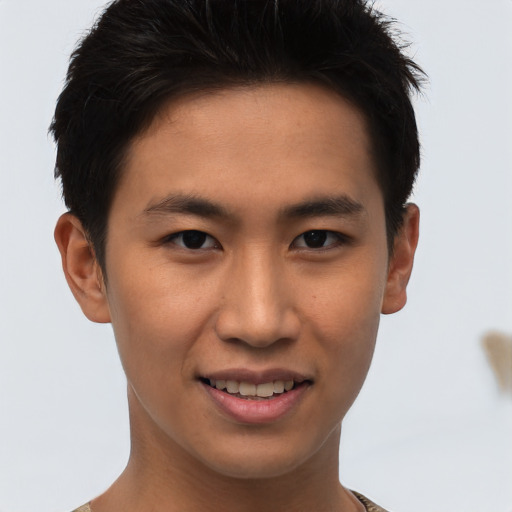 Joyful asian young-adult male with short  brown hair and brown eyes