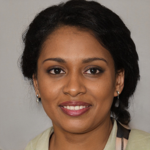 Joyful black young-adult female with medium  brown hair and brown eyes