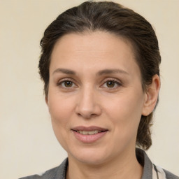 Joyful white adult female with medium  brown hair and brown eyes