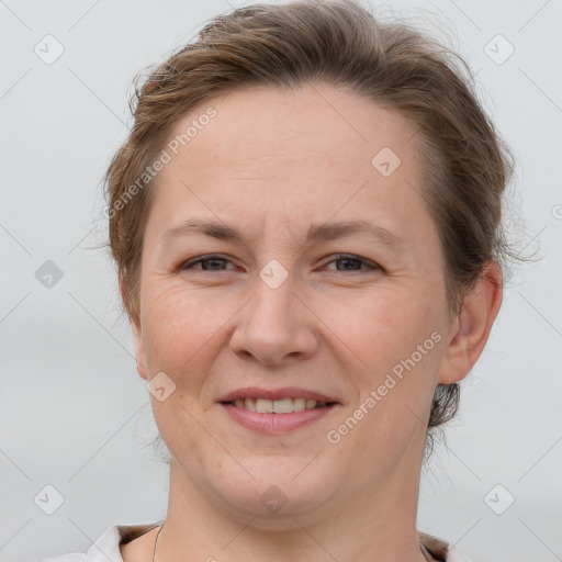 Joyful white adult female with short  brown hair and brown eyes