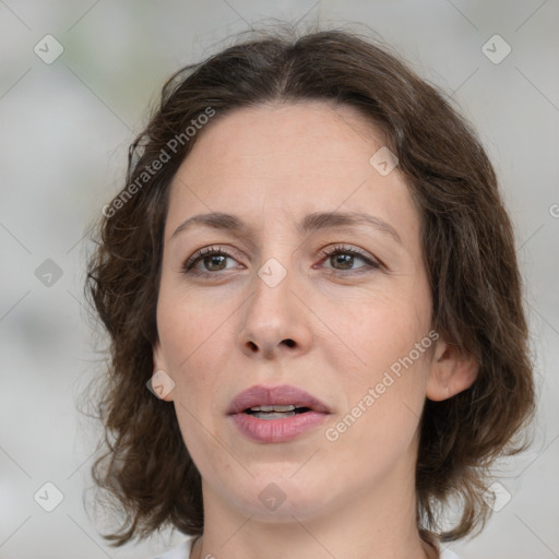 Joyful white adult female with medium  brown hair and green eyes