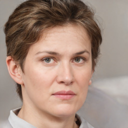 Joyful white adult female with medium  brown hair and grey eyes