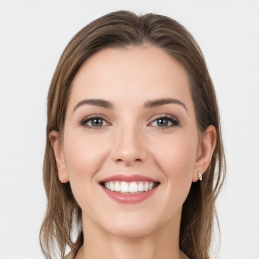 Joyful white young-adult female with long  brown hair and grey eyes