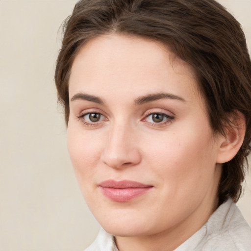 Joyful white young-adult female with medium  brown hair and green eyes