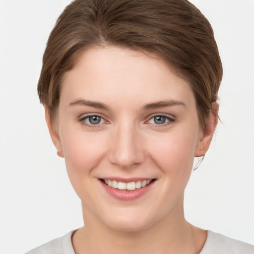 Joyful white young-adult female with short  brown hair and grey eyes