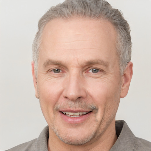 Joyful white middle-aged male with short  gray hair and grey eyes