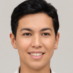 Joyful latino young-adult male with short  brown hair and brown eyes