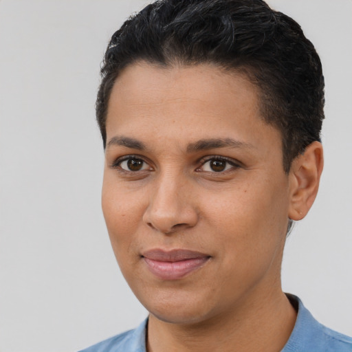 Joyful latino young-adult female with short  black hair and brown eyes
