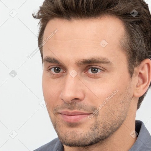 Joyful white young-adult male with short  brown hair and brown eyes