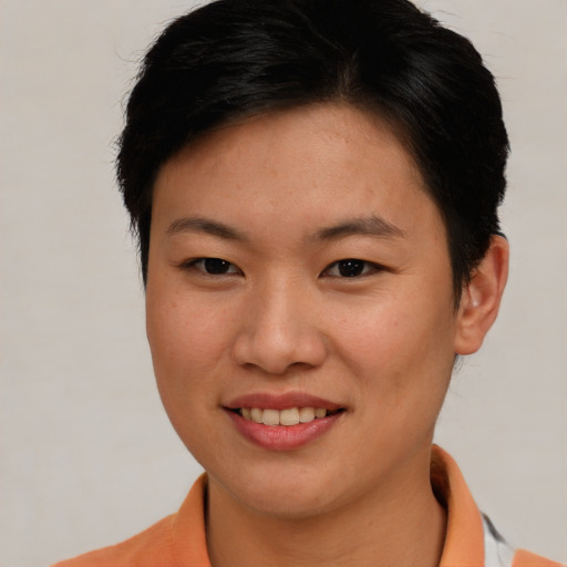 Joyful asian young-adult female with short  brown hair and brown eyes