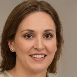 Joyful white young-adult female with medium  brown hair and green eyes