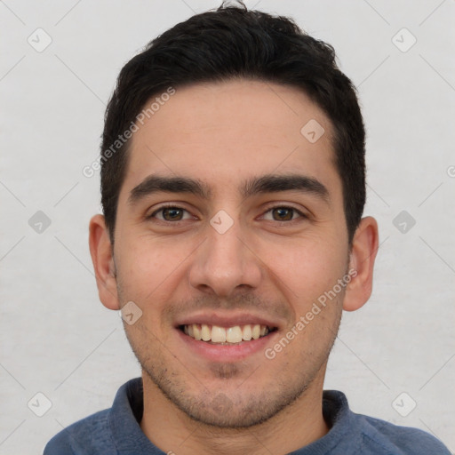 Joyful white young-adult male with short  black hair and brown eyes