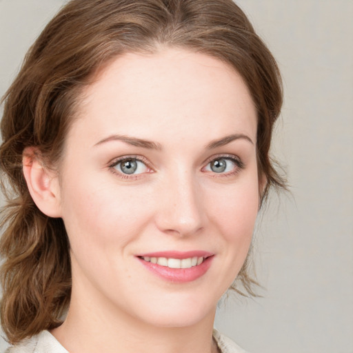 Joyful white young-adult female with medium  brown hair and blue eyes