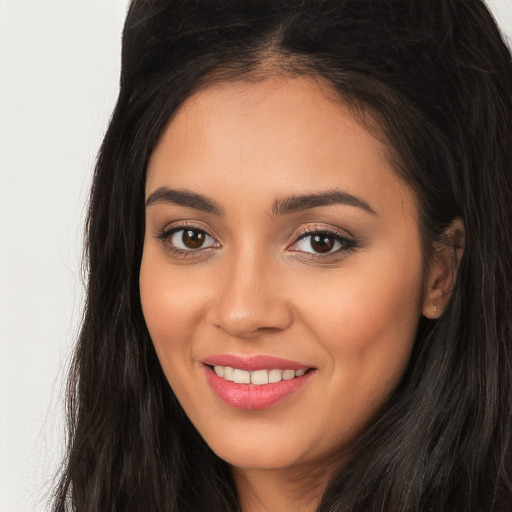 Joyful white young-adult female with long  brown hair and brown eyes