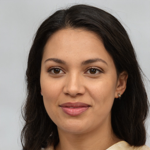 Joyful latino young-adult female with medium  brown hair and brown eyes