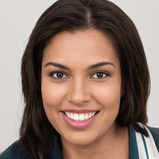 Joyful white young-adult female with long  brown hair and brown eyes