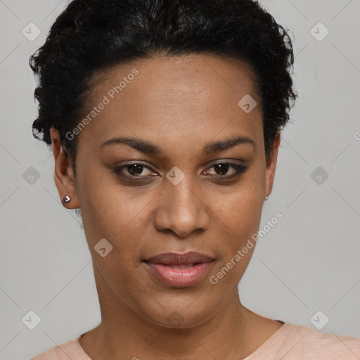 Joyful black young-adult female with short  black hair and brown eyes