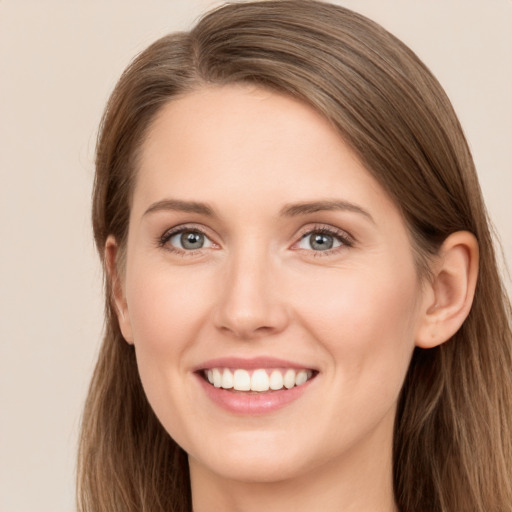 Joyful white young-adult female with long  brown hair and grey eyes