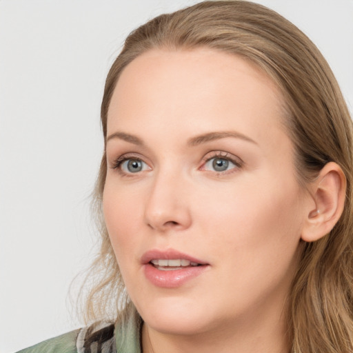 Joyful white young-adult female with long  brown hair and blue eyes