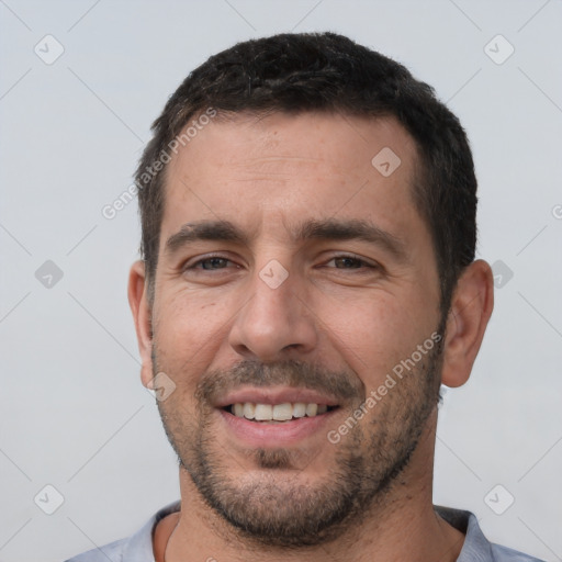 Joyful white young-adult male with short  black hair and brown eyes