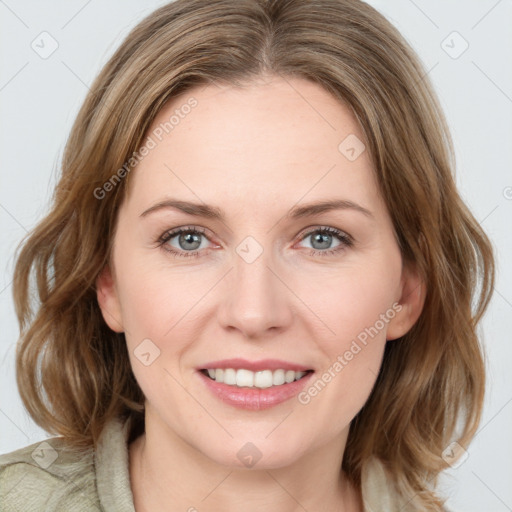 Joyful white young-adult female with medium  brown hair and green eyes