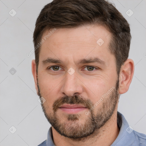 Joyful white adult male with short  brown hair and brown eyes