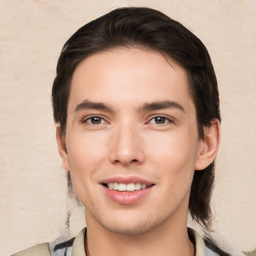 Joyful white young-adult male with medium  brown hair and brown eyes