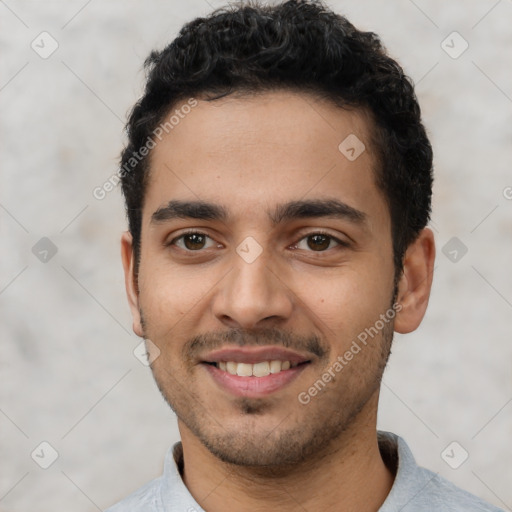 Joyful latino young-adult male with short  black hair and brown eyes