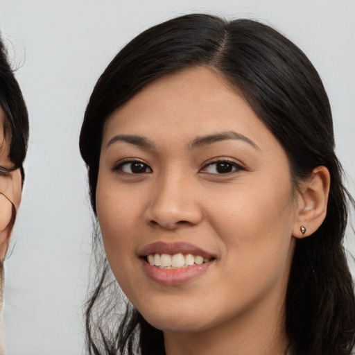 Joyful asian young-adult female with long  black hair and brown eyes