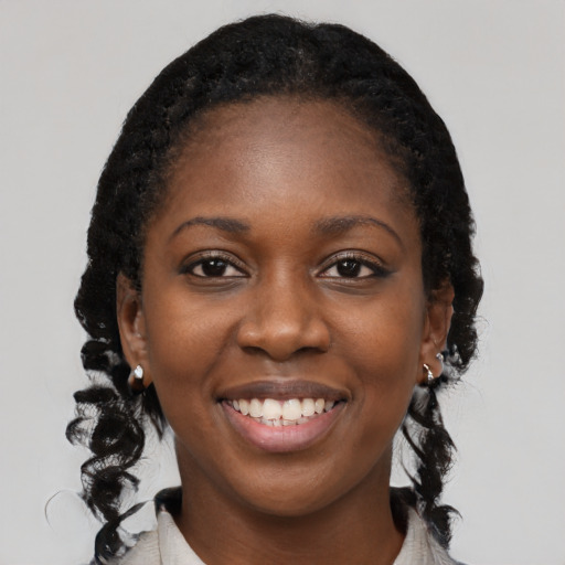 Joyful black young-adult female with medium  black hair and brown eyes