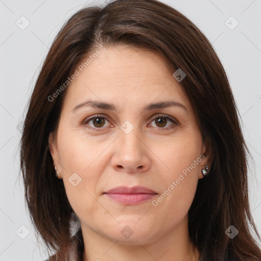 Joyful white adult female with long  brown hair and brown eyes