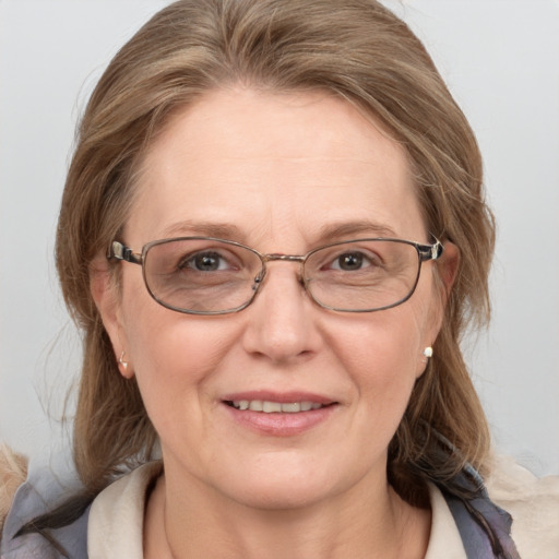 Joyful white adult female with medium  brown hair and blue eyes