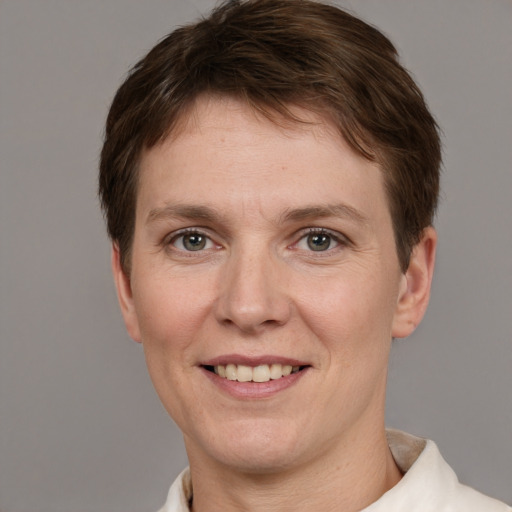 Joyful white adult female with short  brown hair and grey eyes