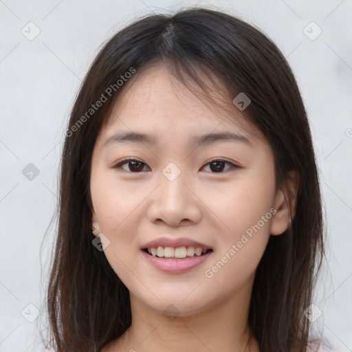 Joyful asian young-adult female with long  brown hair and brown eyes