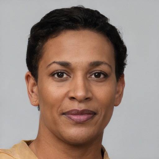 Joyful latino adult female with short  brown hair and brown eyes