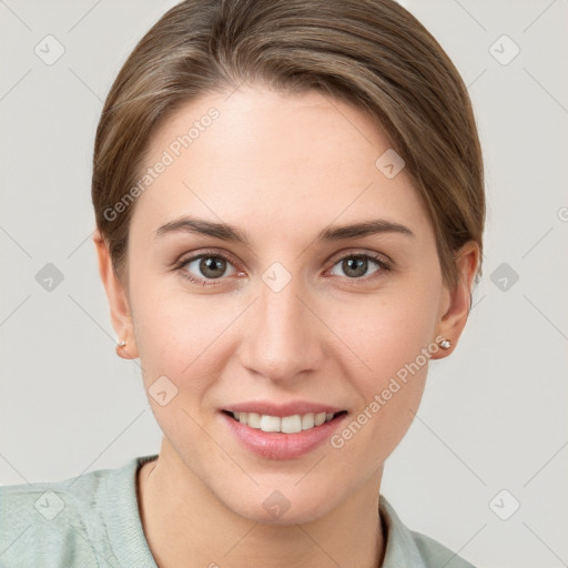 Joyful white young-adult female with short  brown hair and grey eyes