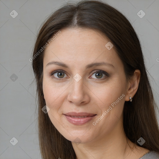 Joyful white adult female with long  brown hair and brown eyes