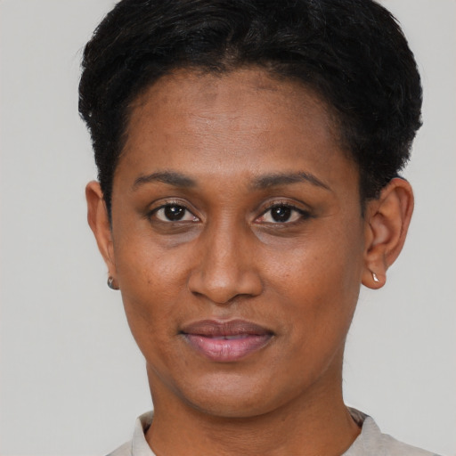 Joyful black young-adult female with short  black hair and brown eyes