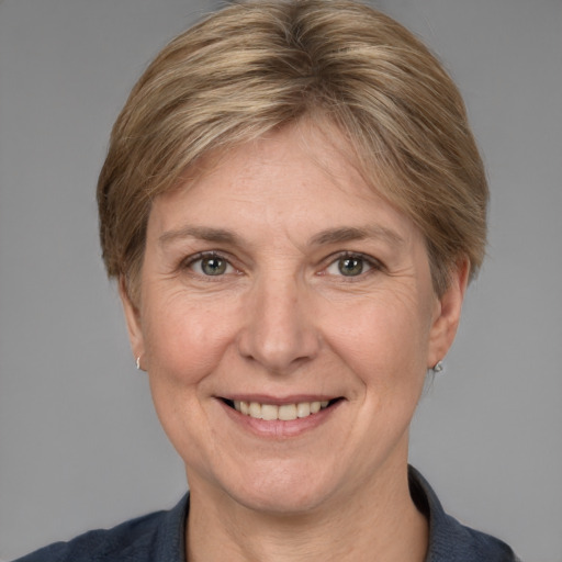 Joyful white adult female with medium  brown hair and grey eyes