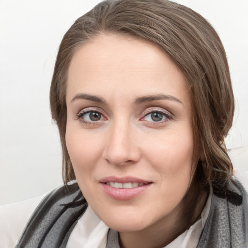 Joyful white young-adult female with medium  brown hair and blue eyes