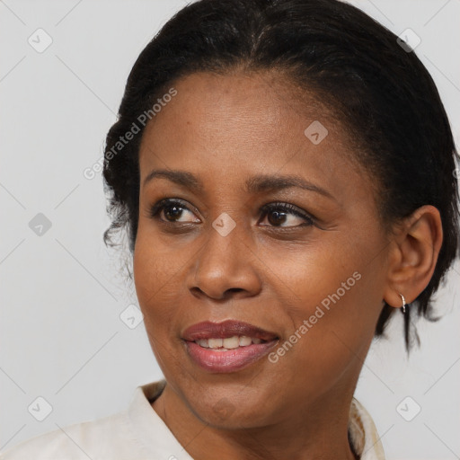 Joyful black adult female with medium  black hair and brown eyes