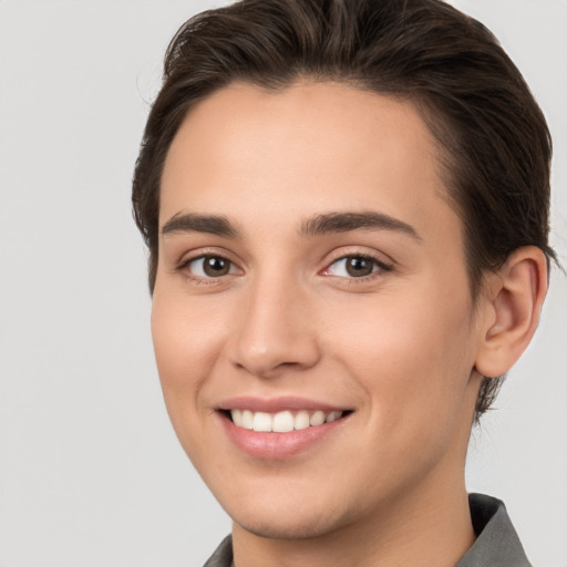 Joyful white young-adult female with short  brown hair and brown eyes