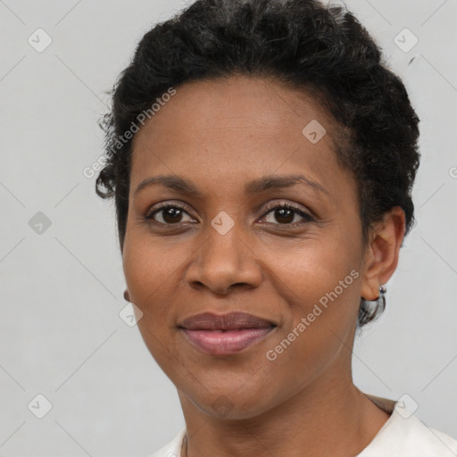 Joyful black young-adult female with short  brown hair and brown eyes