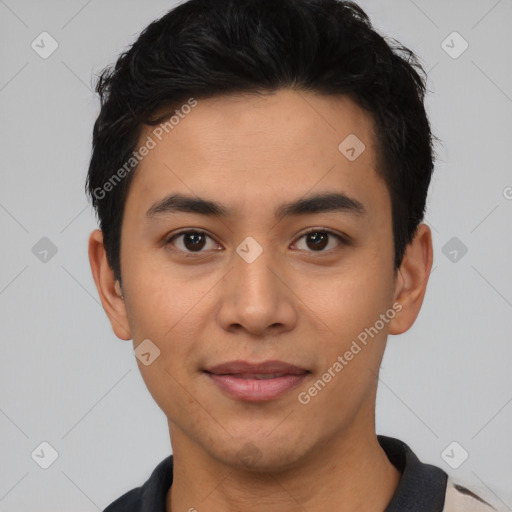 Joyful latino young-adult male with short  black hair and brown eyes