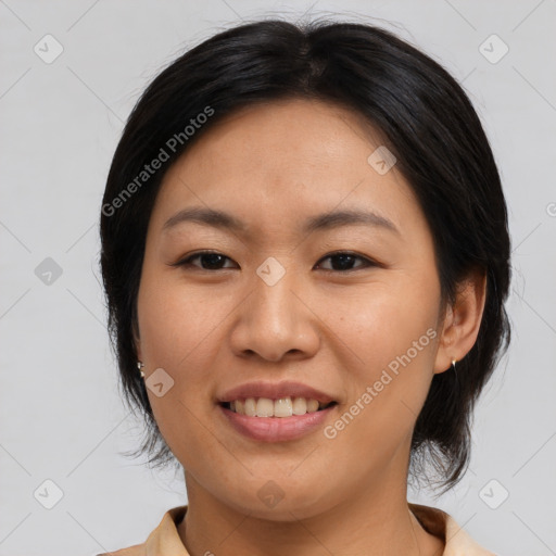 Joyful asian young-adult female with medium  black hair and brown eyes