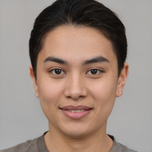 Joyful asian young-adult female with short  brown hair and brown eyes