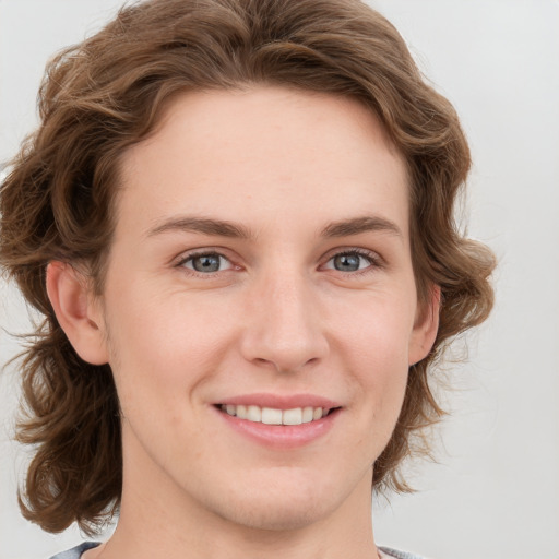 Joyful white young-adult female with medium  brown hair and blue eyes