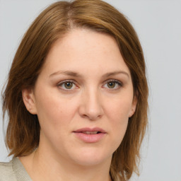 Joyful white young-adult female with medium  brown hair and green eyes