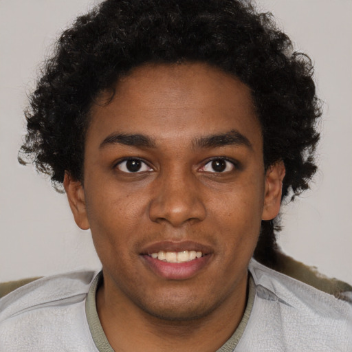 Joyful black young-adult male with short  black hair and brown eyes