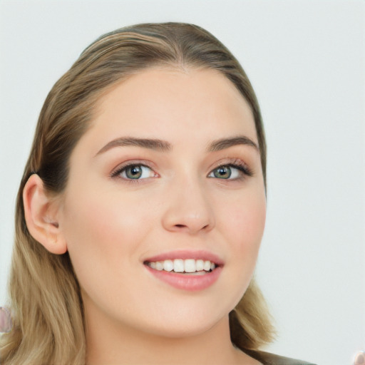 Joyful white young-adult female with long  brown hair and green eyes